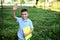 Happy elementary student coming back to school. Adorable schoolboy holding a workbooks and waving hello to camera standing on