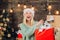 Happy emotion. Euphoria. Crazy comical face. Smiling woman decorating Christmas tree at home. December surprise and
