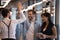 Happy employees colleagues giving high five, greeting in office hallway