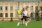 Happy energetic child in formal uniform hold school bag jumping in scholyard, schooling