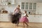 Happy energetic grandmother teach ball dances active little girl grandchild