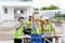 Happy engineers and formats, male and female colleagues in safety vests with helmets taking selfies at under-construction building