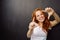 Happy enthusiastic young redhead woman