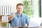 Happy entrepreneur gesturing thumbs up at office