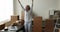 Happy entrepreneur woman dancing at laptop in e-commerce storage room