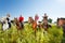 Happy equestrians riding horses in summer field