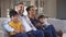 Happy ethnic family watching television together