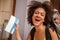 Happy and euphoric backpacker female tourist shows ticket for he