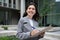 Happy European business lady reviewing paperwork, signing papers outdoor