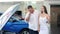 A happy European couple is discussing cars, considering a luxury new model. Family purchase of a new car. Discuss the