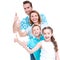 Happy european family with children shows the thumbs up sign