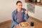 Happy european pregnant woman savoring homemade pasta, enjoy eating spaghetti, sitting at table in kitchen, above view