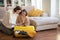 Happy european young women with smartphone, tickets and suitcase with clothes, preparing for travel together