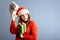 Happy europian Santa Woman is smiling and holding Gift Box for Christmas or New Year. Isolated on gray background