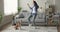 Happy excited beagle owner dancing at home with trick dog