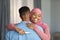 Happy Excited Black Muslim Woman Holding Positive Pregnancy Test And Hugging Husband