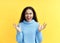 Happy excited black woman celebrate success  on yellow background