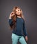 Happy excited crazy kid girl gesturing the ok sign the hand on grey background