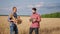 Happy and excited farmer take some posing in front of the camera his son take the pictures from electronic tablet the