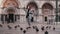 Happy excited female tourist with pigeon sitting on arm takes smartphone photos on city square in Venice slow motion.