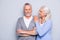 Happy excited lovely tender gentle cute elderly people are smiling and embracing, isolated on grey background