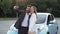 Happy excited loving couple making selfie on smartphone after purchasing car.
