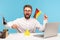 Happy excited man pointing finger at toy paper house holding flag of germany in hand, moving into another country, sitting at