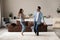 Happy excited millennial couple dancing together in living room