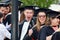 Happy excited university students graduating graduation day