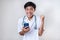 Happy Excited Young Asian doctor man success doing wining gesture holding a mobile phone