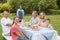 Happy extended family having a barbecue being cooked by father