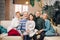 Happy extended family sitting on sofa together