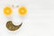 Happy face of fruit and seeds. The Grinning smiling face is made from oranges and pumpkin seeds, eyebrows of garlic. Background of