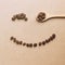 Happy face shaped of coffee beans with wooden spoon