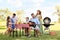 Happy families with little children having picnic