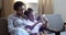 Happy family african american ama nanny black woman older sister sitting with cute baby girl daughter on couch in living