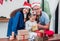 Happy family Asian family wear santa claus hat unwrap Christmas