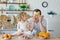 Happy family autey and daughter in the kitchen. Parenting is a game. Choose between fruit or cookies. The concept of healthy