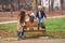 Happy family in autumn on the nature. Mother and her sons having fun outdoors. Autumn holidays. Young family walk in autumn park