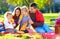 Happy family on autumn picnic in park