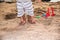 Happy family baby boy and father walk barefoot on sand beach