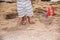 Happy family baby boy and father walk on sand beach