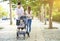 Happy family with baby carriage walking in the park