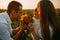 Happy family with baby has a fun and plays with the sunflower inflorescence