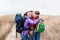 Happy family with backpacks hugging