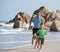 Happy family on beach playing, father with son