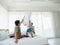 Happy family in bed room concept.The happy family jumping on the bed.blured moving girl playing on bed