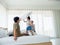 Happy family in bed room concept.The happy family jumping on the bed.blured moving girl playing on bed