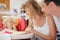 Happy family with blond little girl eating bread