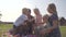 Happy family blowing confetti from their hands in the yard of their house.